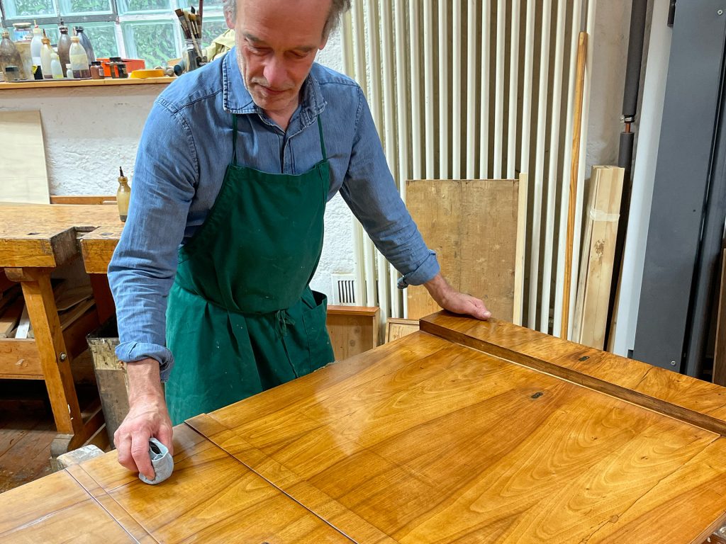 Thomas Langenholt, Restaurator für Holz und Möbelobjekte, beim Polieren einer Holztür